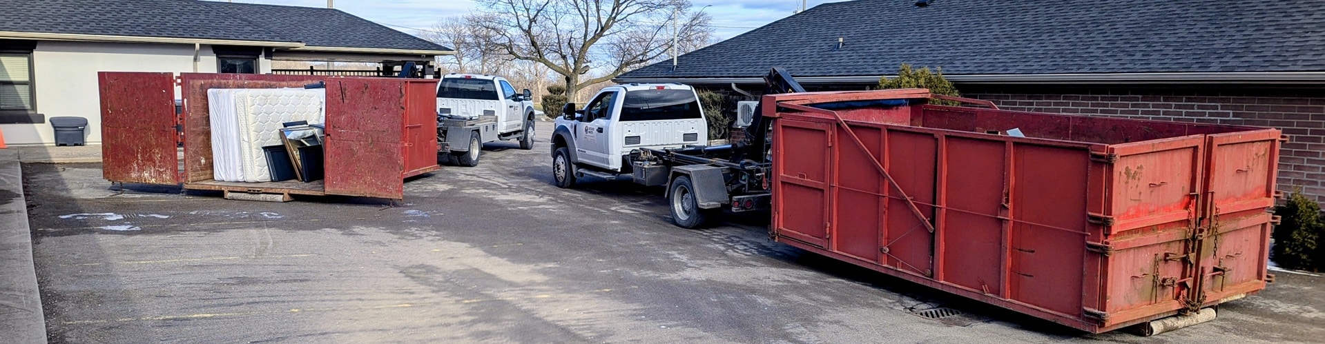 Commercial property cleanup service in Burlington removing illegal dumping in parking lot